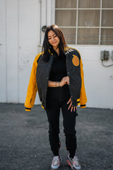 Full-length shot of the oversized Soul Evans bomber styled with black cargo pants.