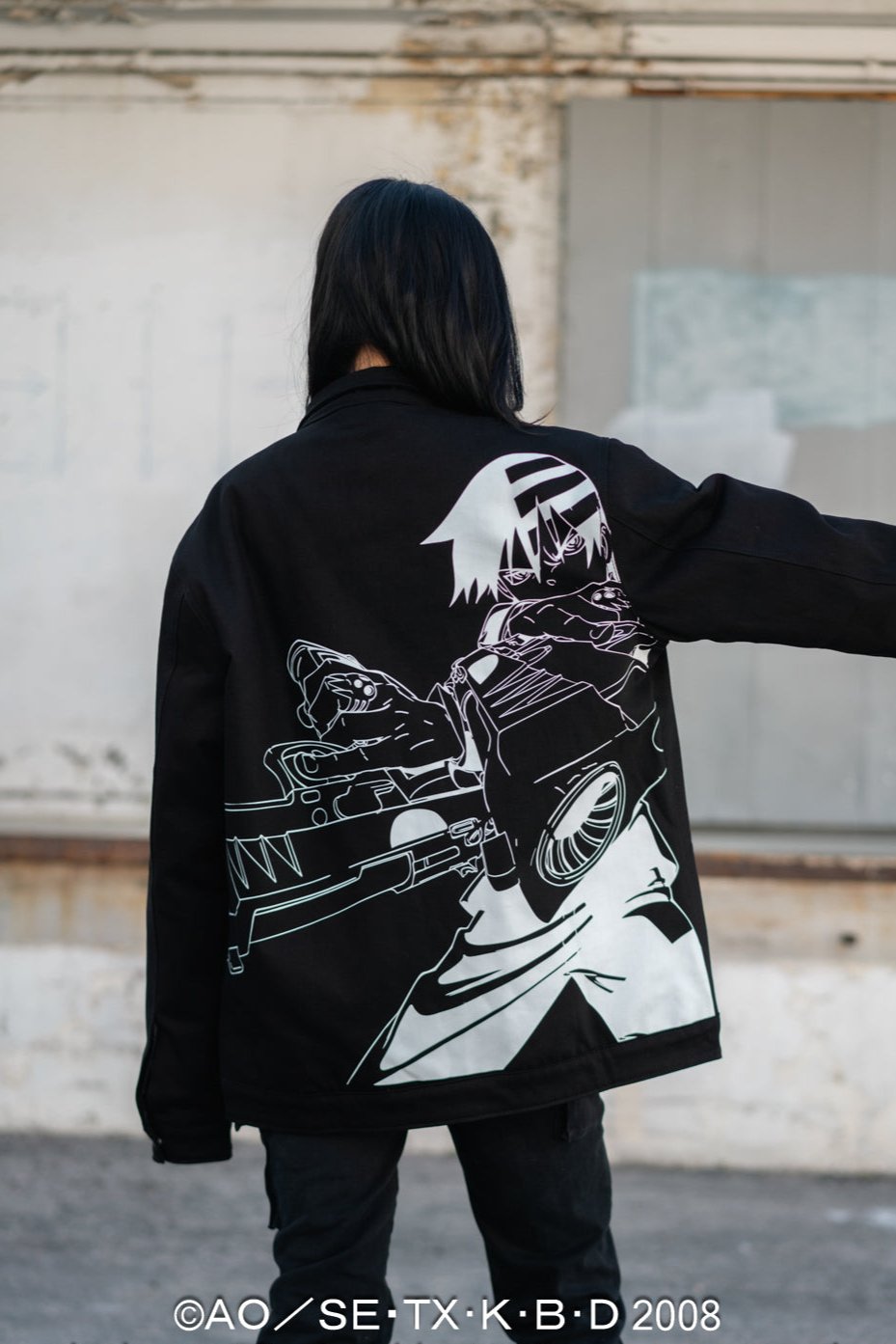Wide shot of the back of the jacket emphasizing the large-scale character embroidery.