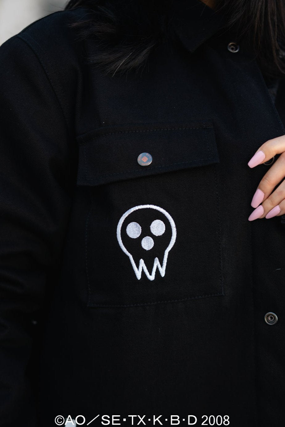 Close-up of the white Death the Kid skull icon embroidered on the chest pocket.