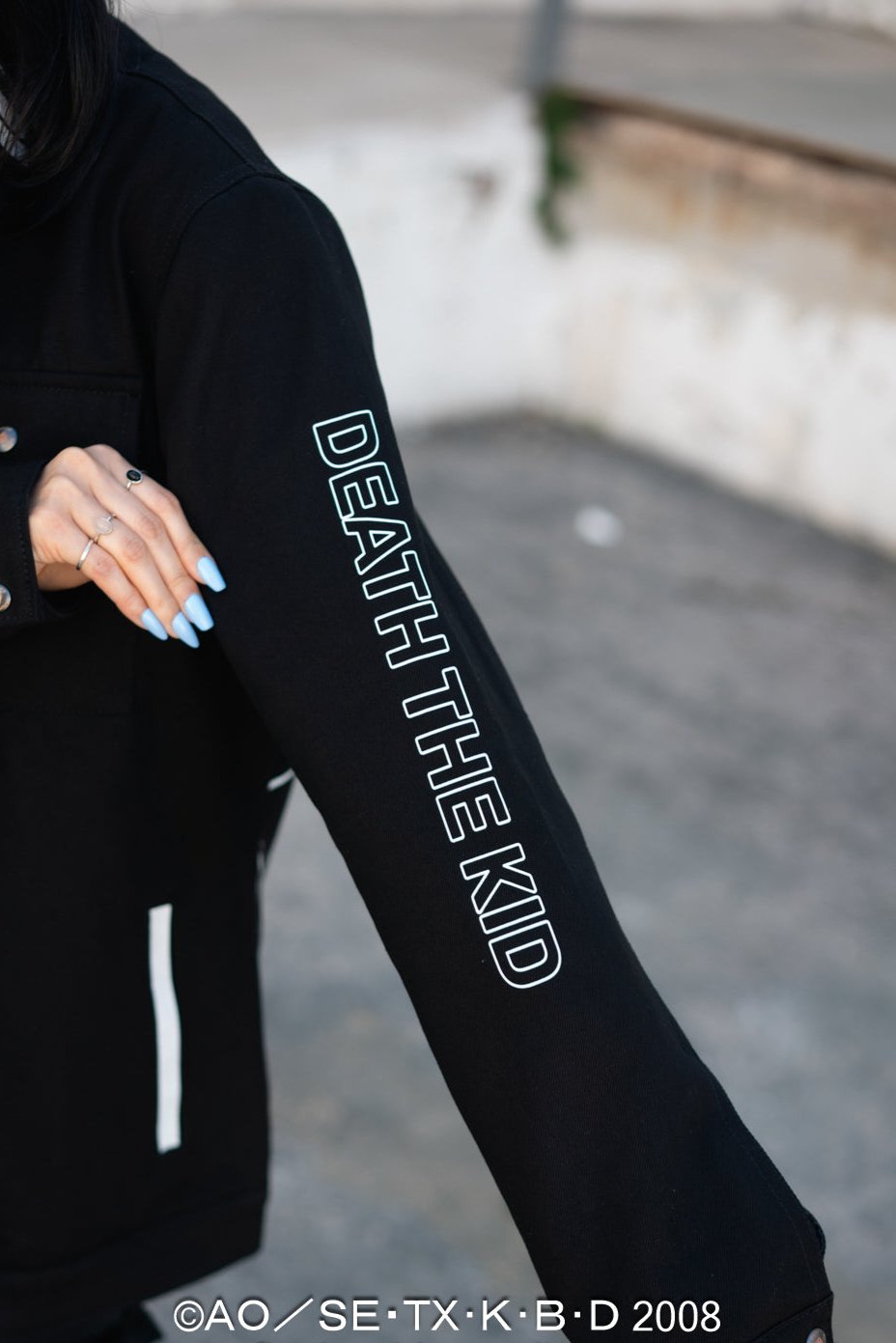 Close-up of the "DEATH THE KID" text embroidery along the sleeve.