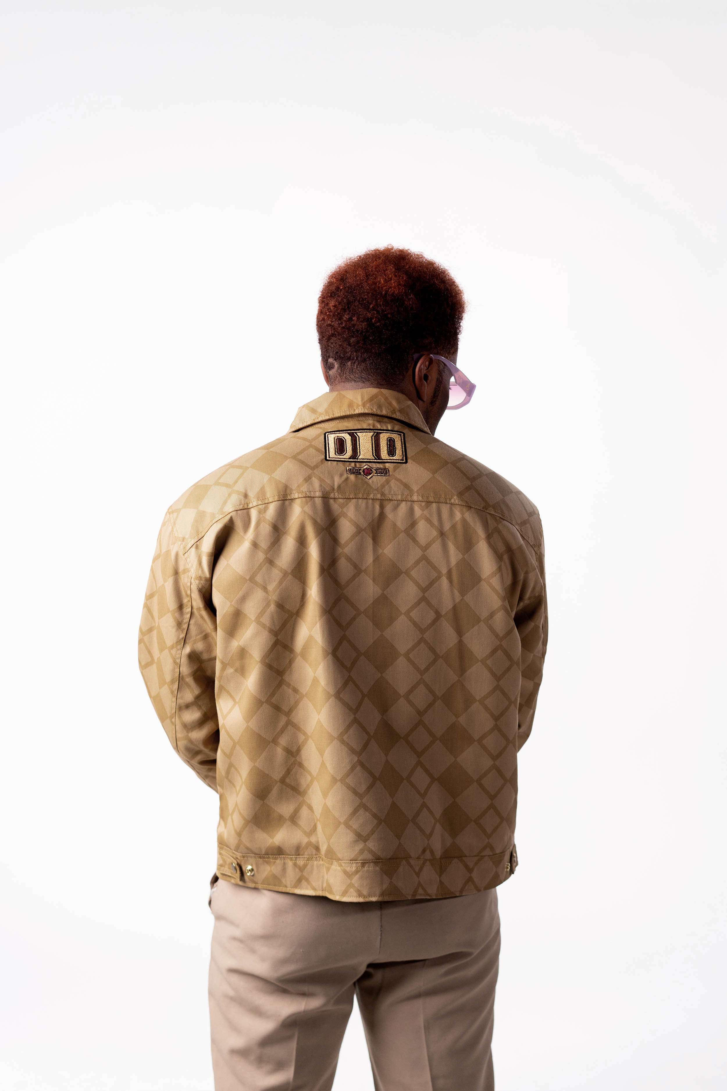 Back view of the gold DIO jacket showcasing the oversized fit.