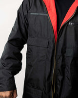 Close-up of the utility pockets and contrast red lining on the black side of the coat.