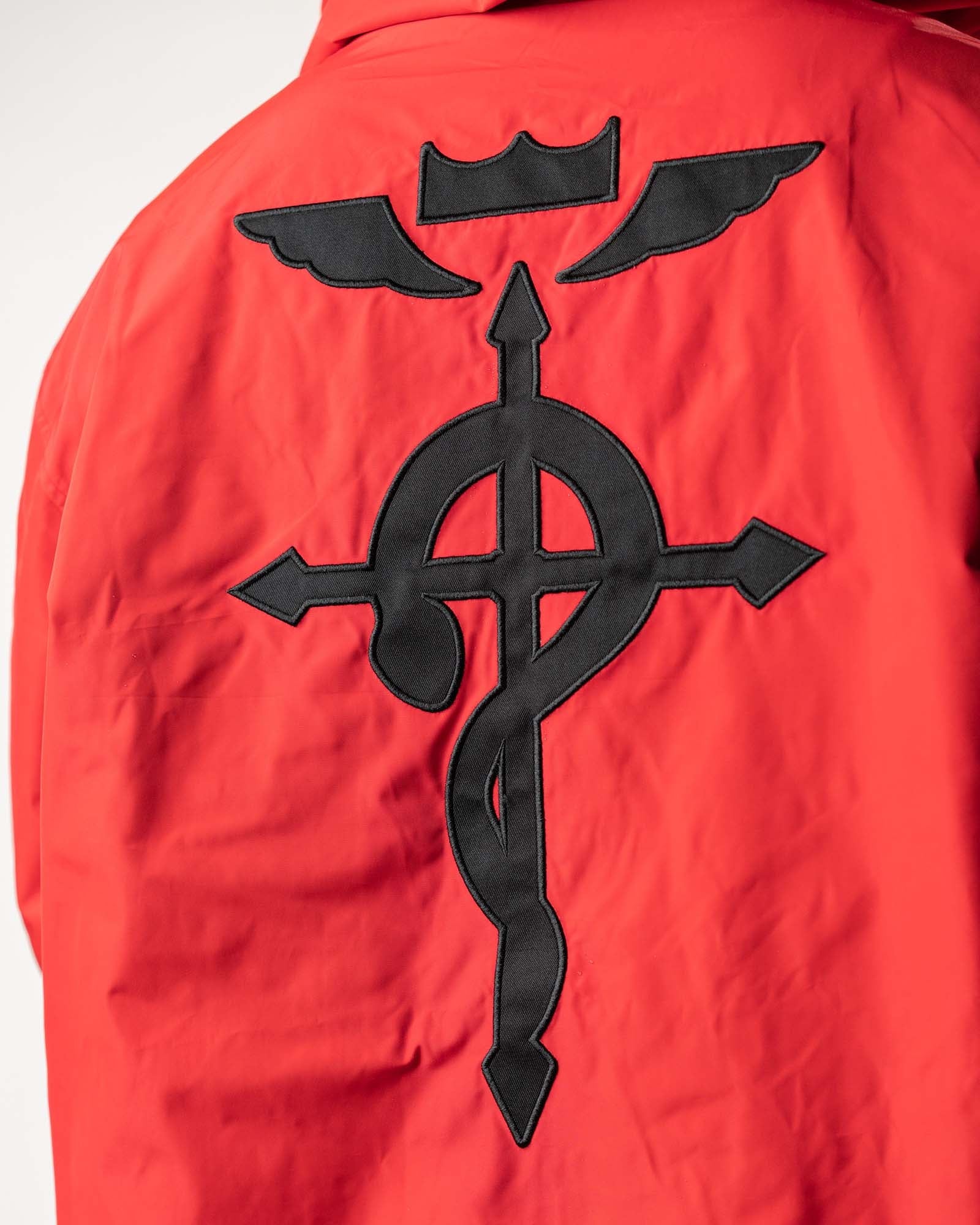 Detailed close-up of the black Flamel symbol on the vibrant red polyester side.