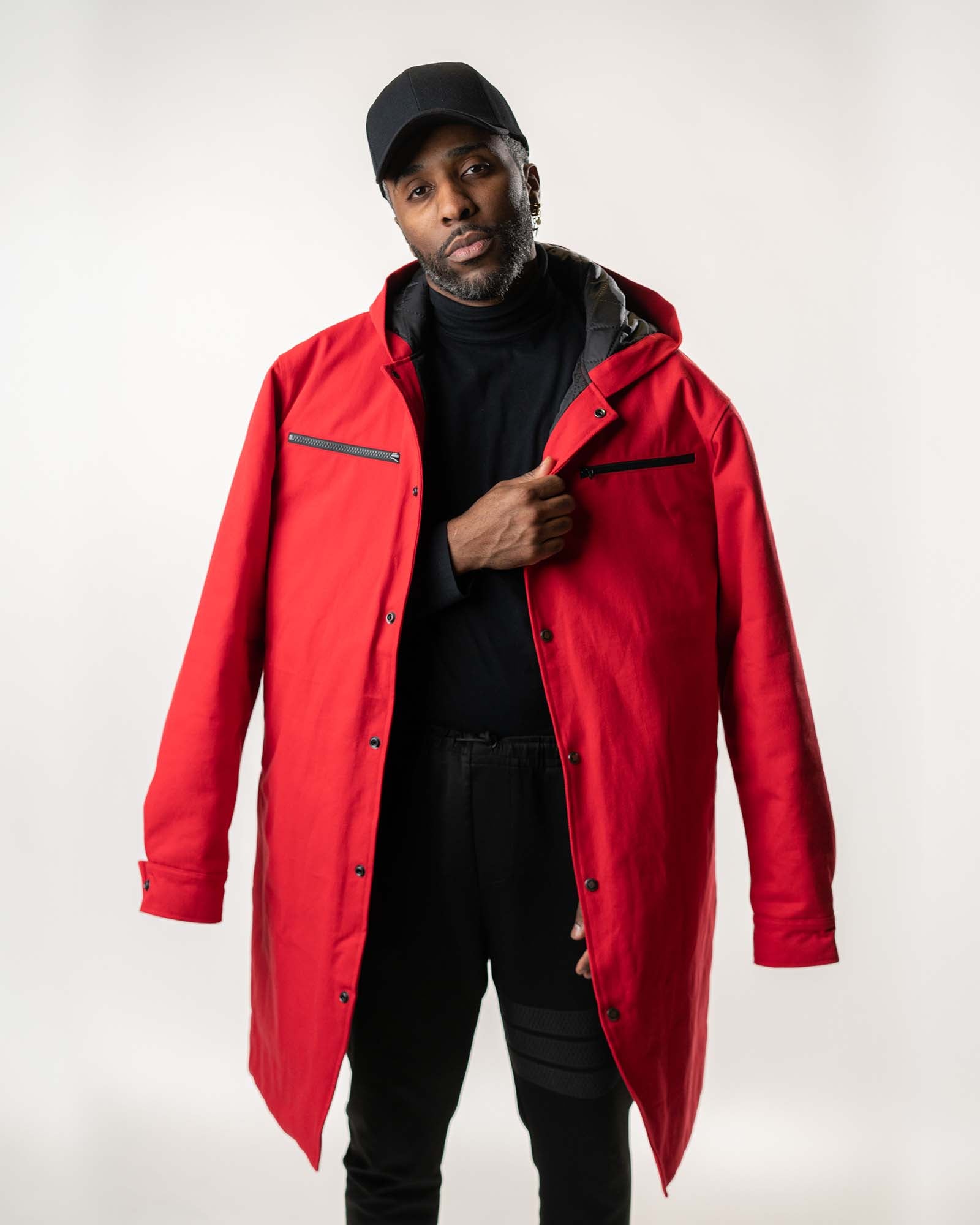 Full-body studio shot of the red long-line denim jacket and black apparel.