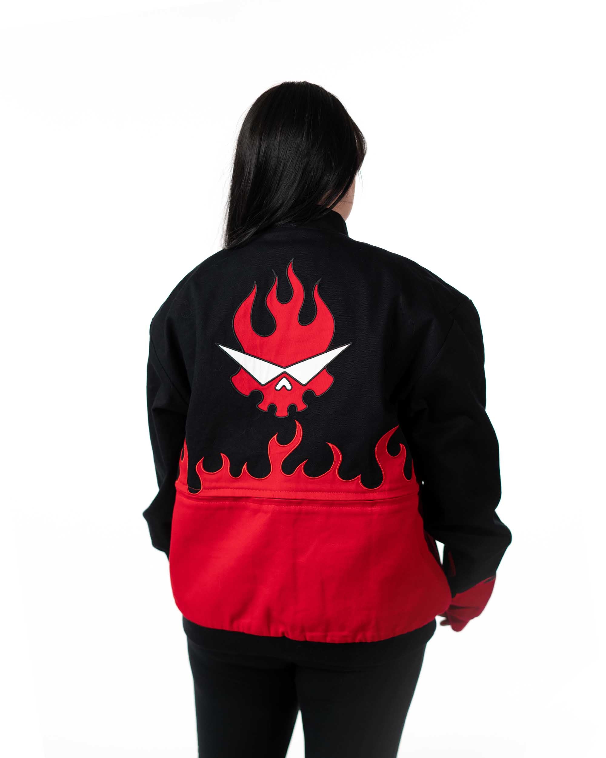 Back view of female model wearing full-length black Gurren Lagann jacket with red flaming skull logo