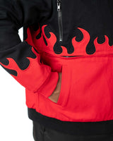 Close-up of the side pocket on the cropped black Gurren Lagann jacket, featuring a small flaming skull emblem and red flames.