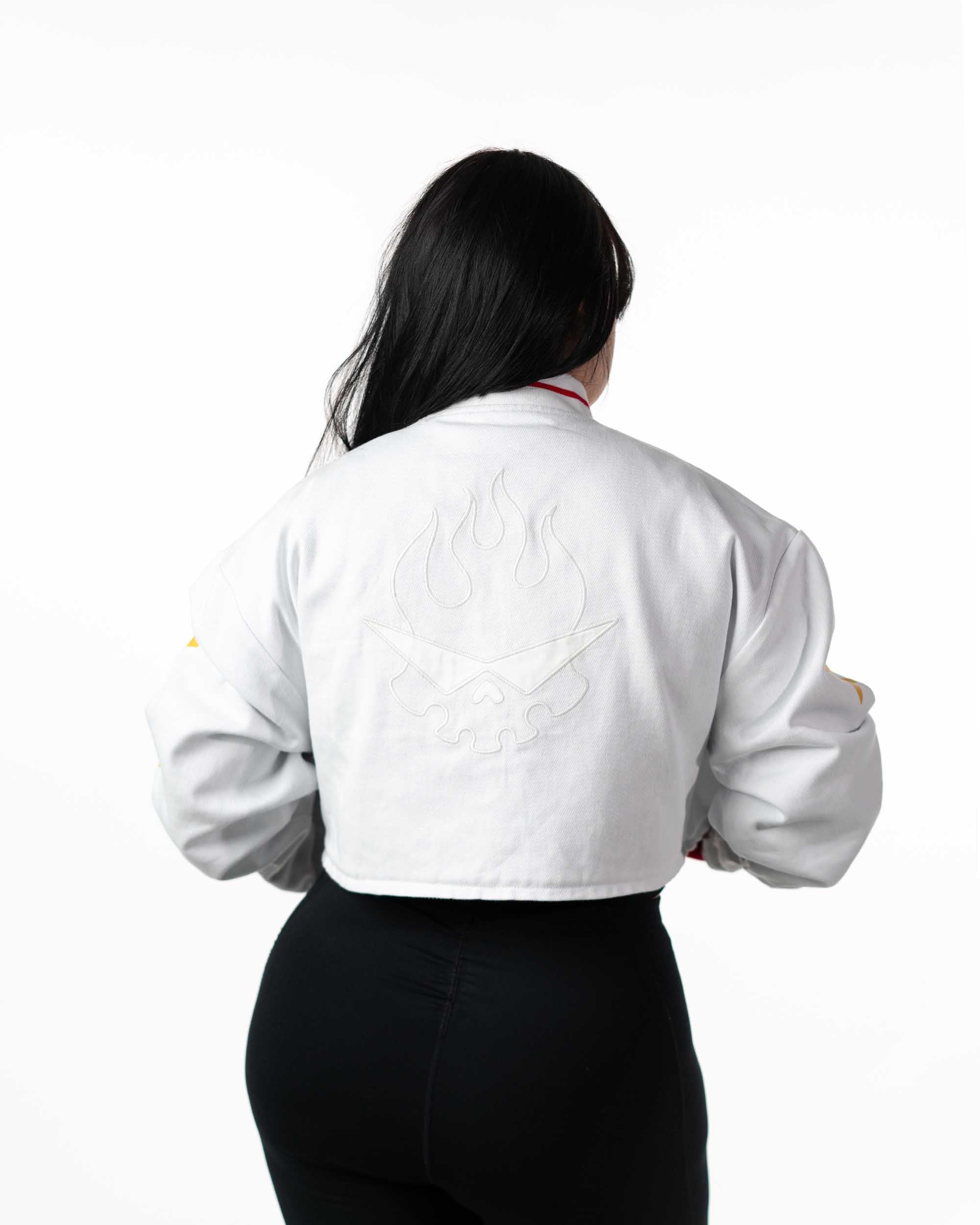 Back view of female model with hood down, wearing cropped white Gurren Lagann jacket.
