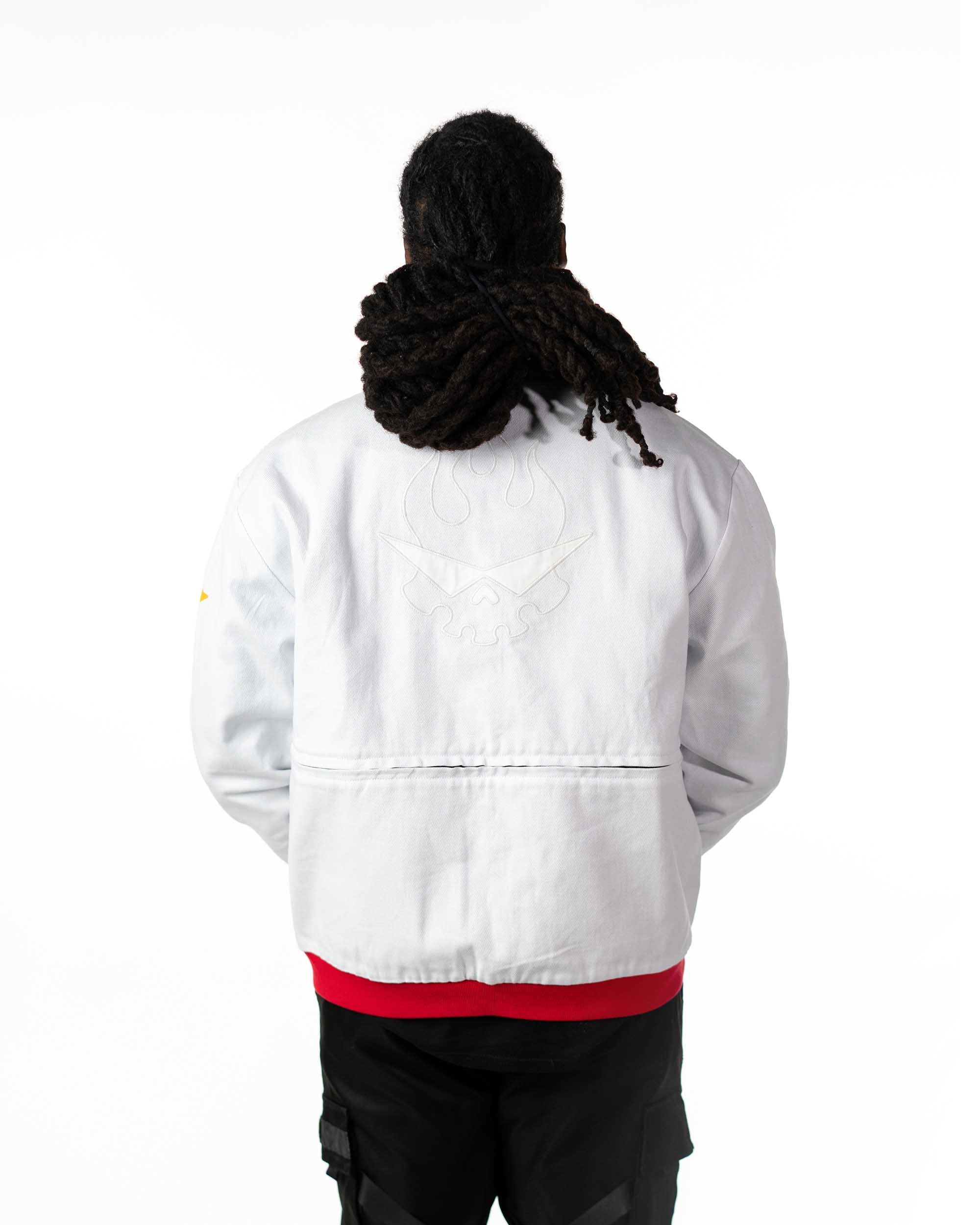Back view of male model in cropped white Gurren Lagann jacket with hood down and red stripe details.