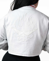 Back view of cropped white Yoko Gurren Lagann jacket on a model, showing subtle white-on-white embroidery pattern.
