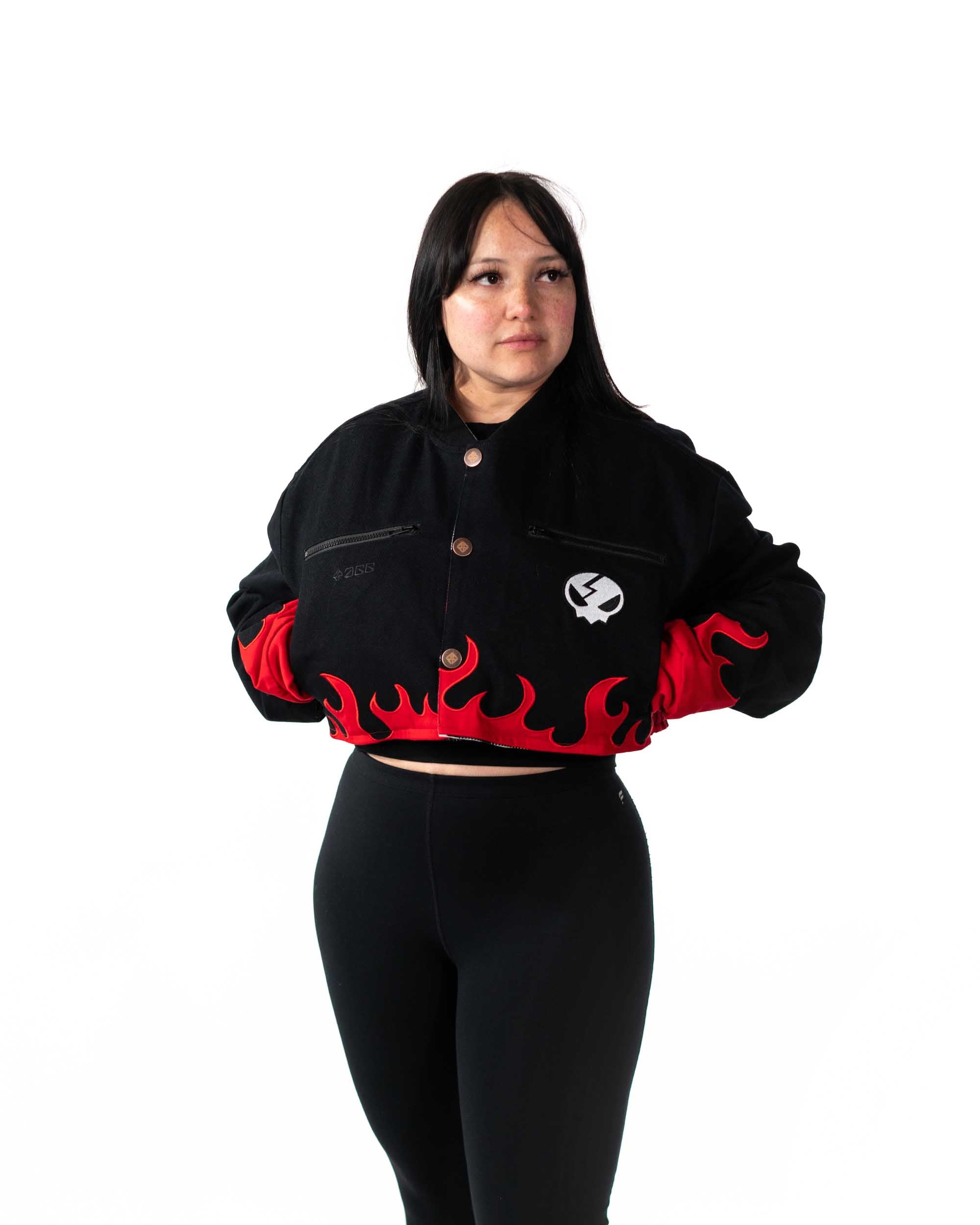 Female model wearing cropped white Gurren Lagann jacket with large red star on front, facing forward.