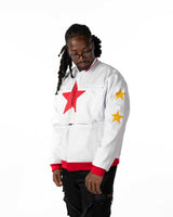 Front view of male model wearing cropped white Gurren Lagann jacket with large red star and yellow sleeve star.