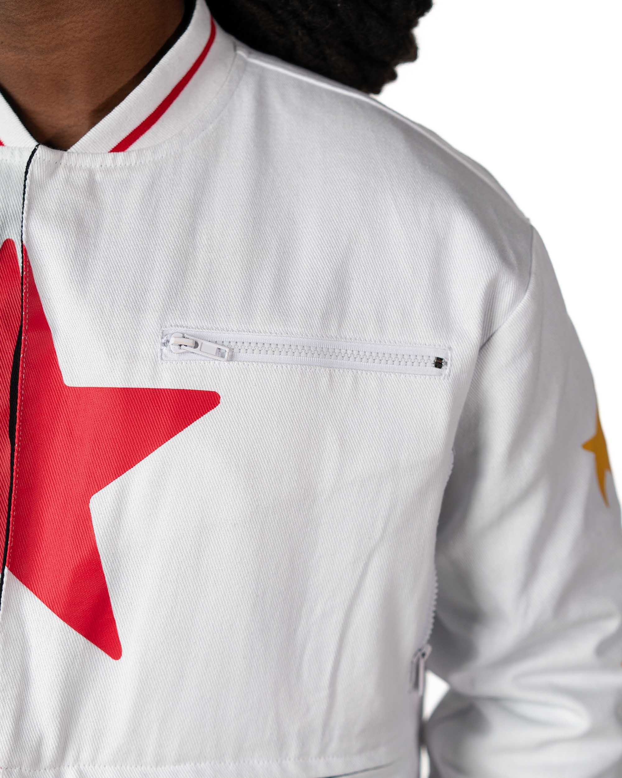 Tighter close-up on the chest of a male model wearing cropped white Gurren Lagann jacket, focusing on the large red star.