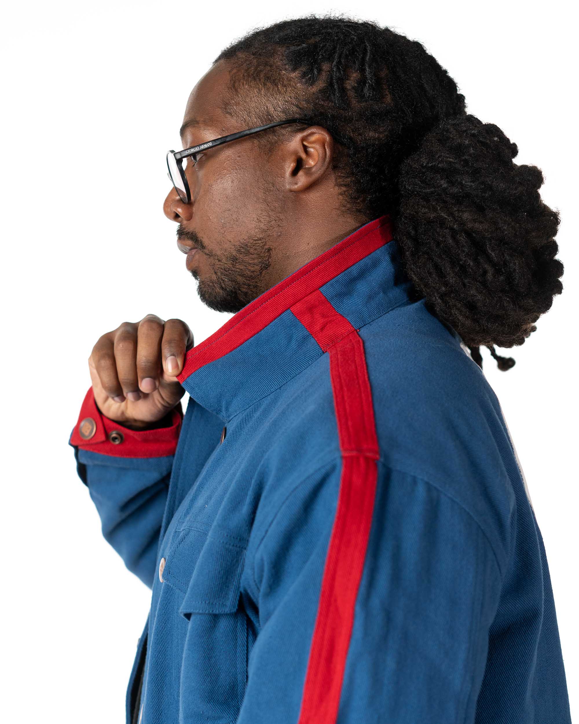 Side view of Male model wearing the Simon Gurren Lagann denim jacket showing off collar