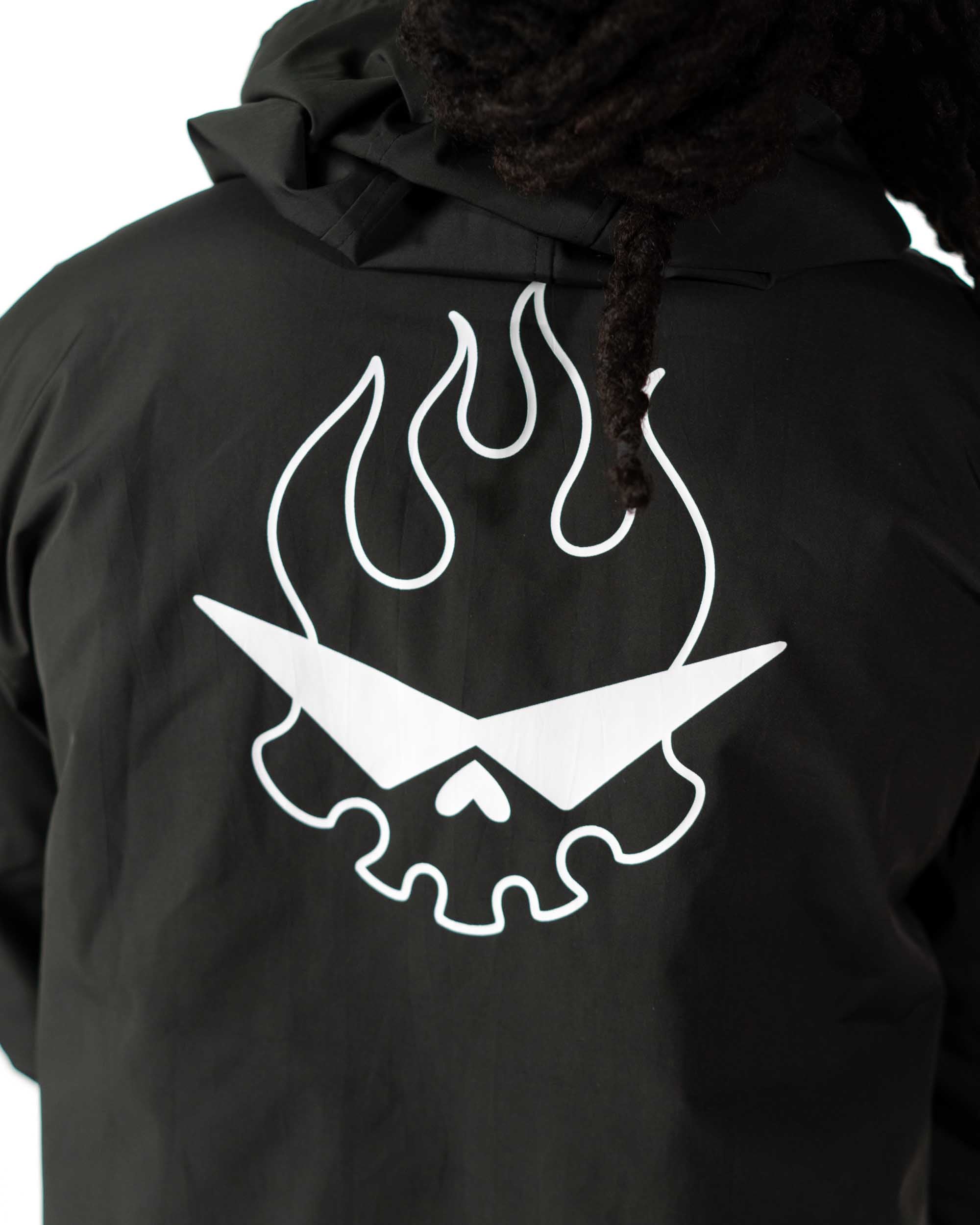 Close up of the white Team Dai Gurren flaming skull screen print on the black side of the coat