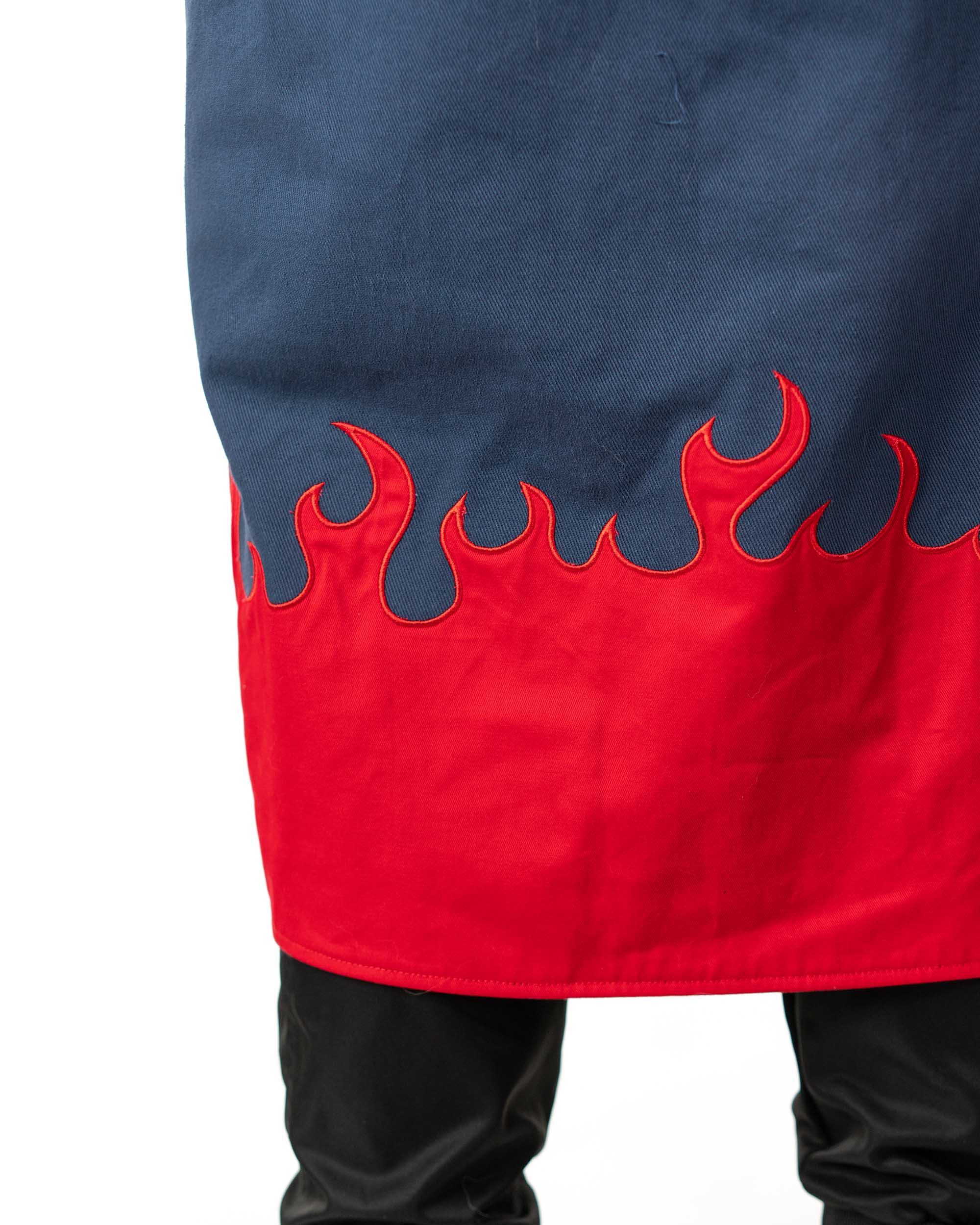 Close up of the bold red flame screen print on the bottom hem of the long coat