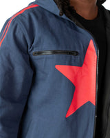 Detailed shot of the red star screen print on the front of the blue denim long coat