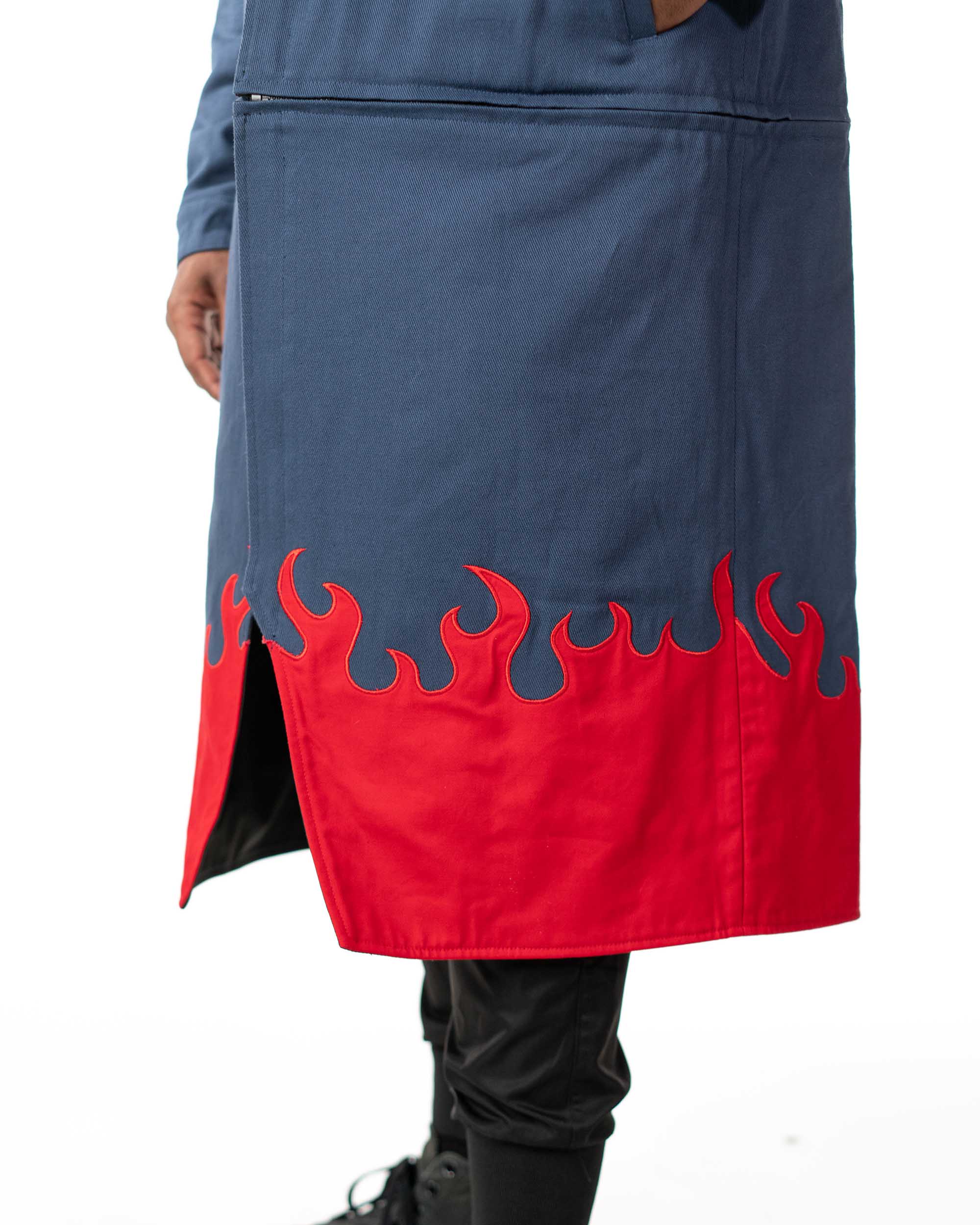 Close up view of the split hem on the blue denim side showing the screen printed red flame pattern