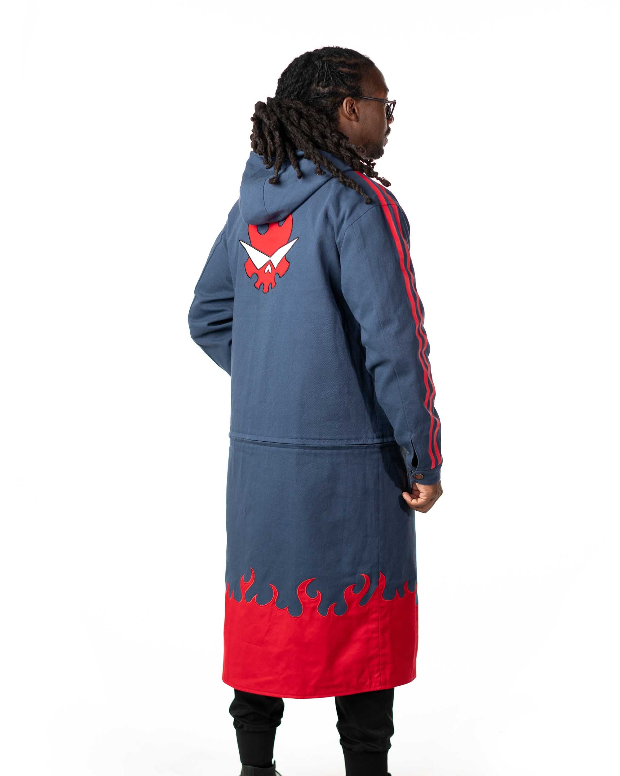 Full length rear view of the blue denim side of the reversible long coat showing the red graphic placement