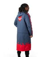 Full length rear view of the blue denim side of the reversible long coat showing the red graphic placement