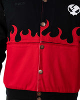Close-up of the front lower part of the black Gurren Lagann jacket on a male model, showing red flames and small flaming skull emblem.