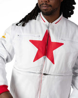 Close-up of male model wearing cropped white Gurren Lagann jacket, showing large red star on front and yellow star on sleeve.