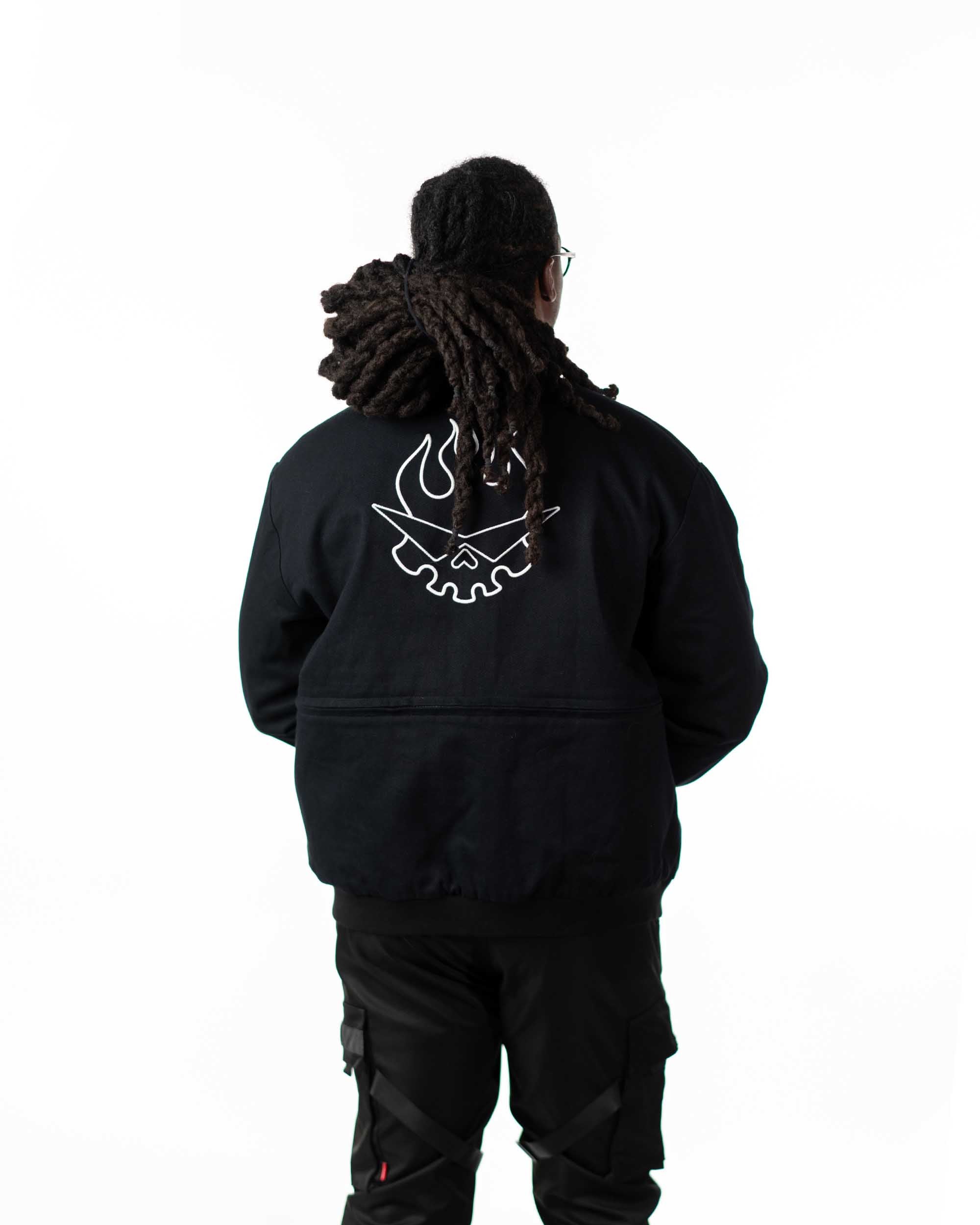 Detailed close-up of the white flaming skull back embroidery on the black side of the reversible jacket