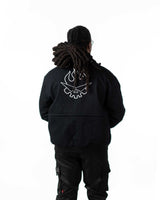 Detailed close-up of the white flaming skull back embroidery on the black side of the reversible jacket