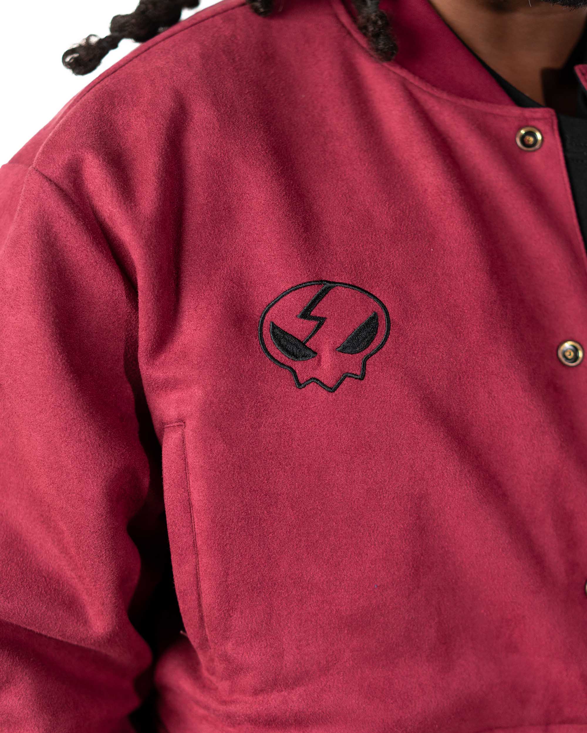Close-up of the sleeve on the maroon jacket highlighting the vibrant orange and yellow flame print