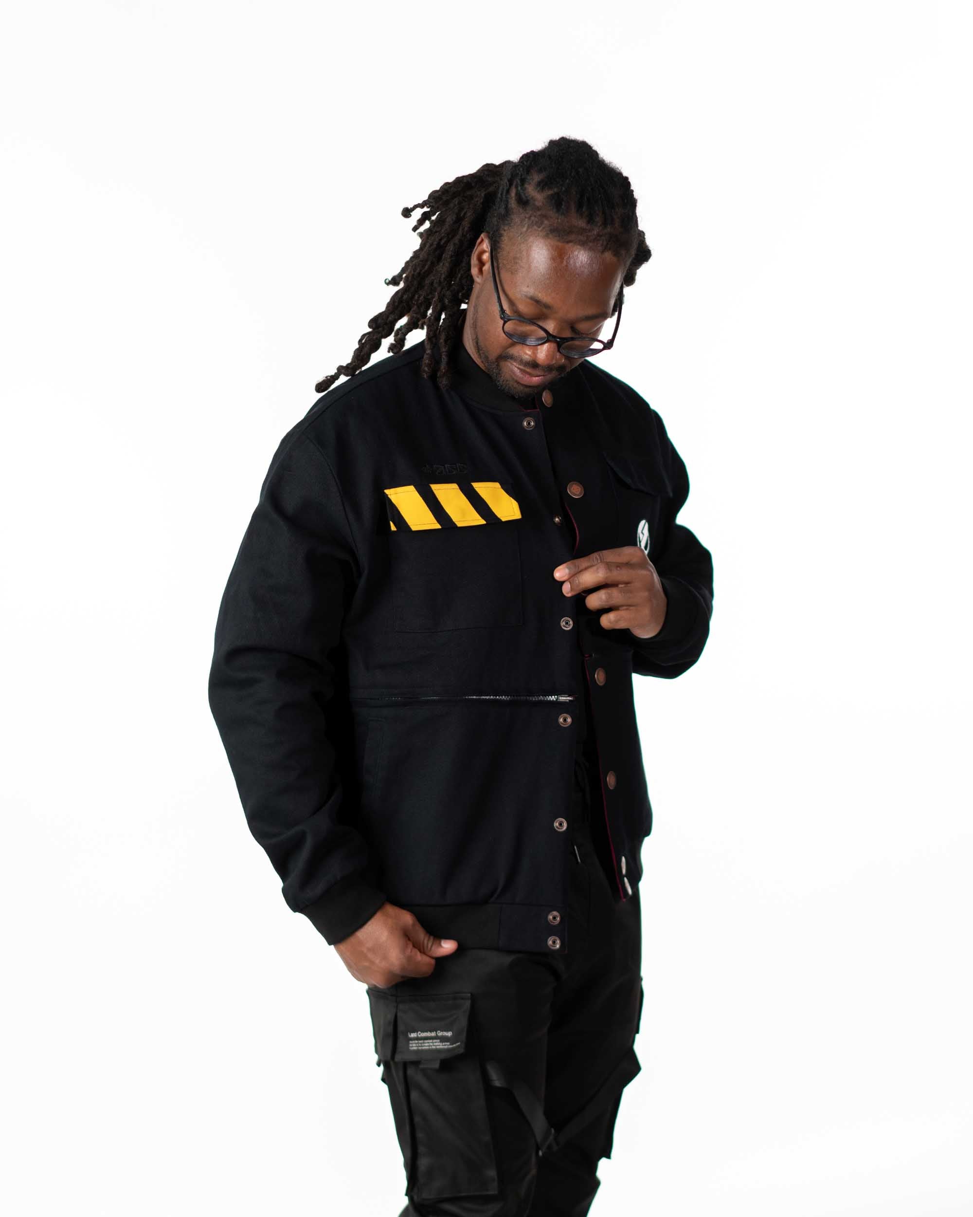 Full rear view of male model in the black side of the reversible jacket showing the large white skull graphic
