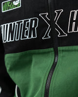Detailed close up of the front zipper and bold Hunter x Hunter lettering across the green panel