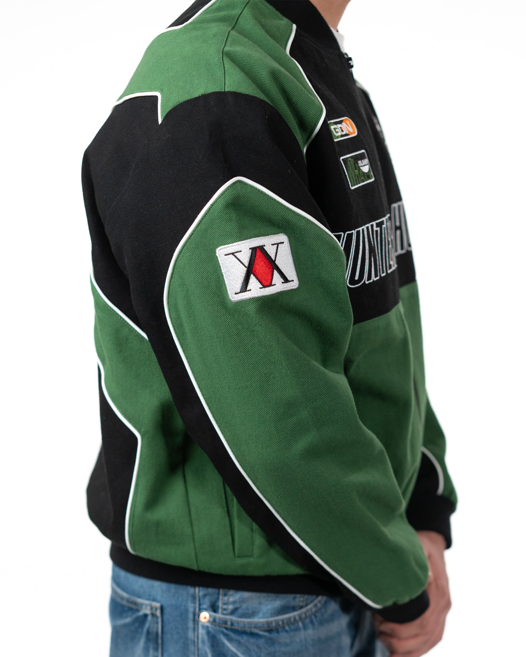 Side profile of the Gon racing jacket on a model highlighting the green and white arm patch