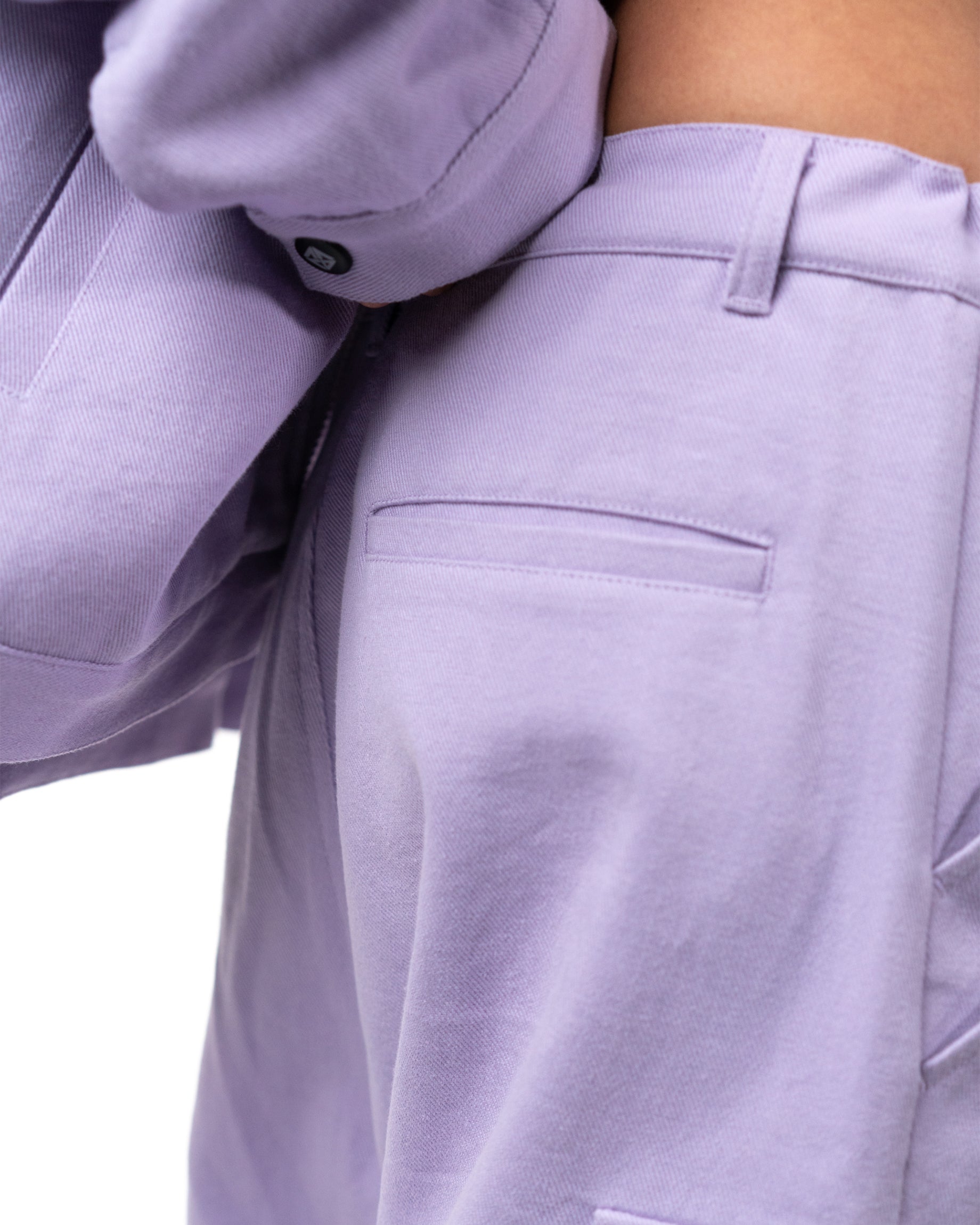 Close up of the clean back welt pocket construction on the lavender cargo pants