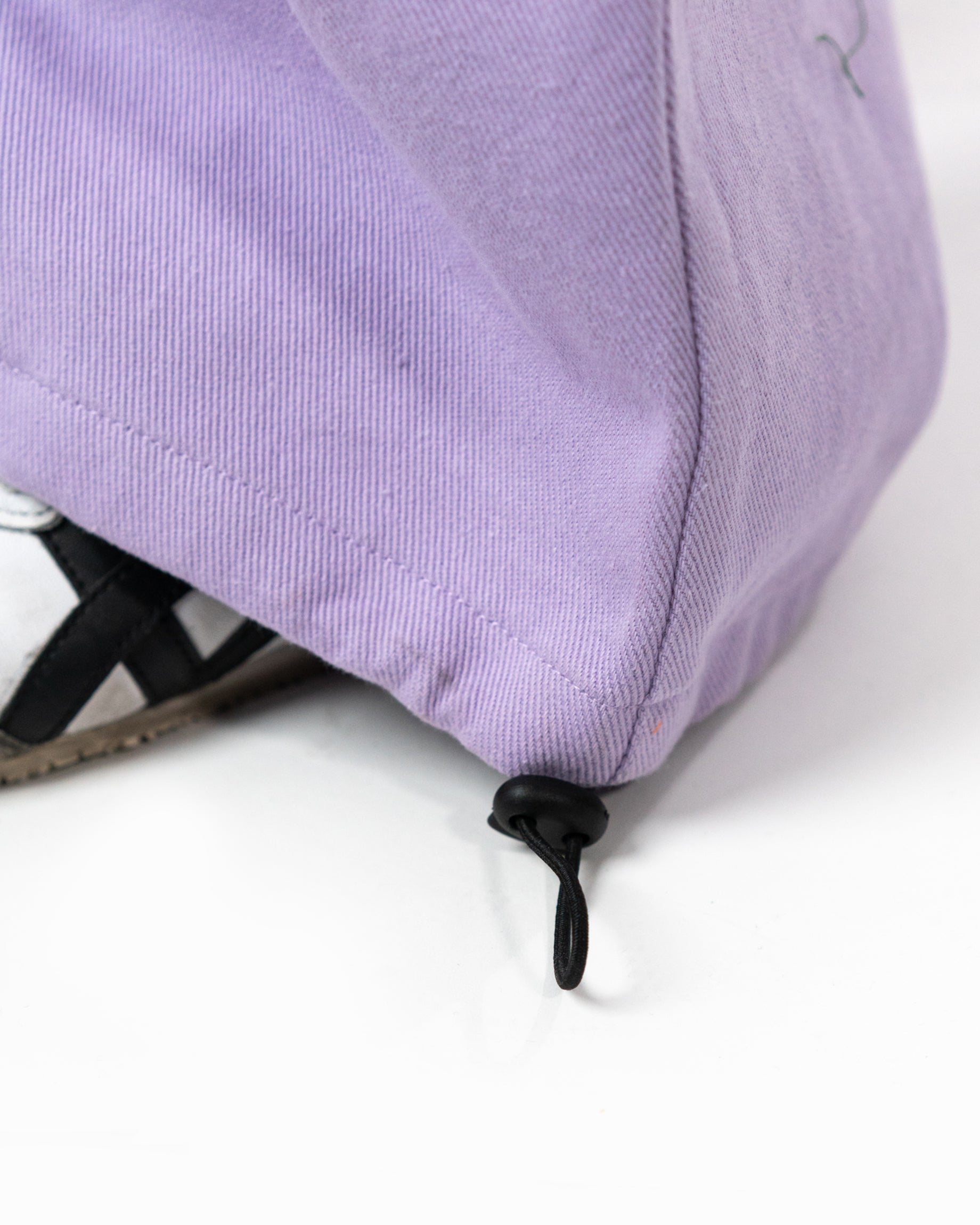Close up of the adjustable drawcord toggle at the bottom hem of the cargo pants