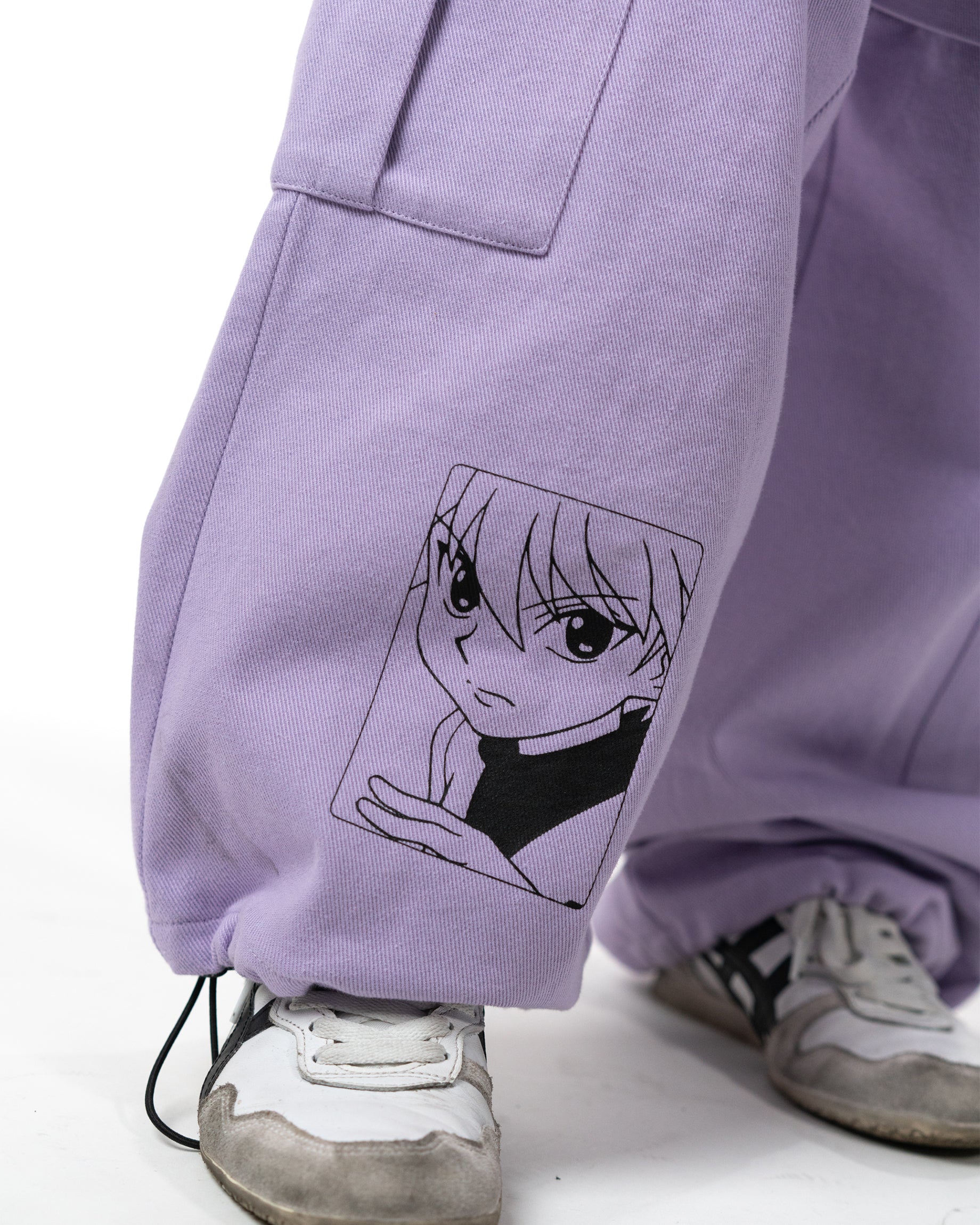 Close up of the lavender pants leg hem featuring a line art print of Killua Zoldyck
