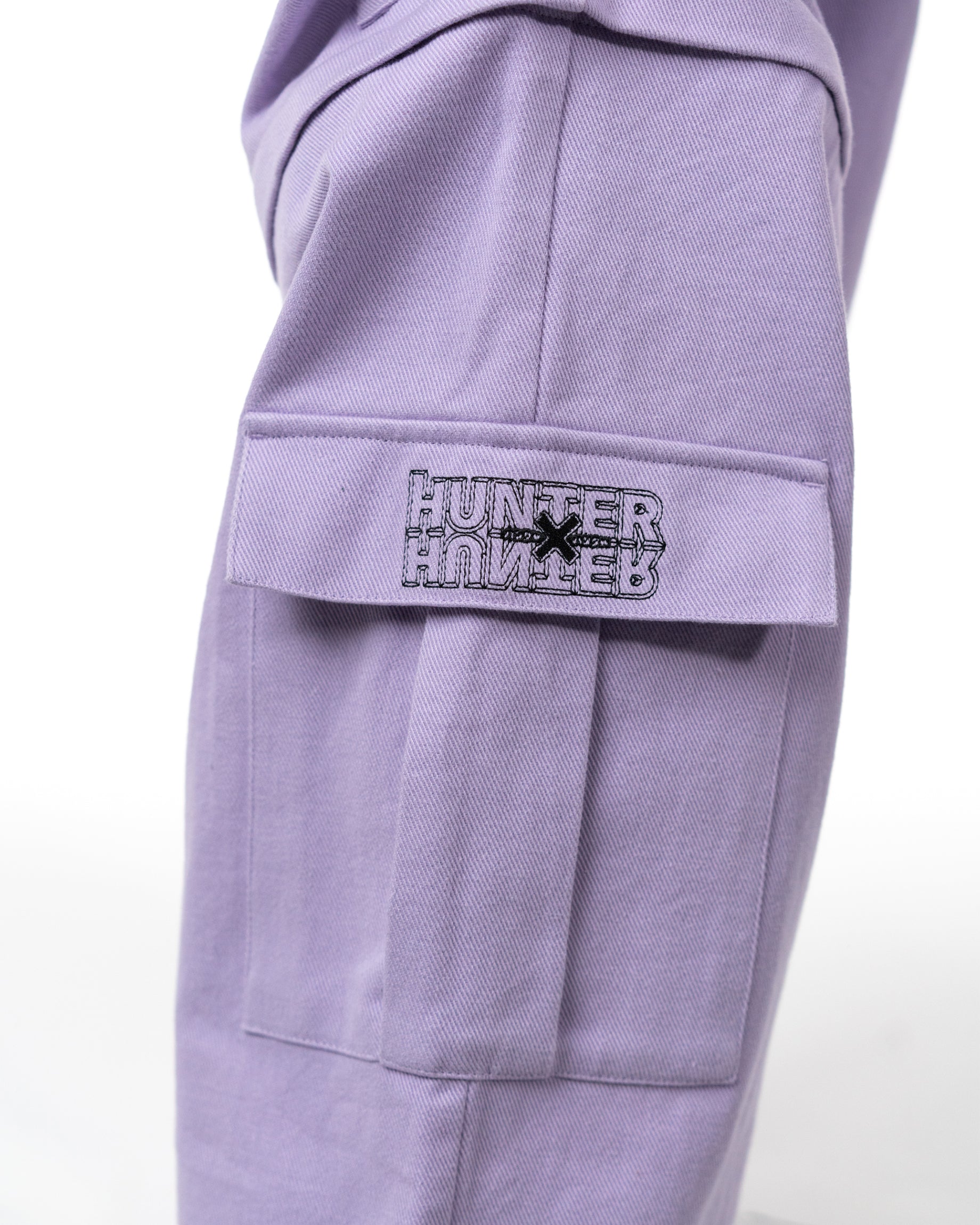 Detailed shot of the cargo pants pocket with the embroidered Hunter x Hunter license patch