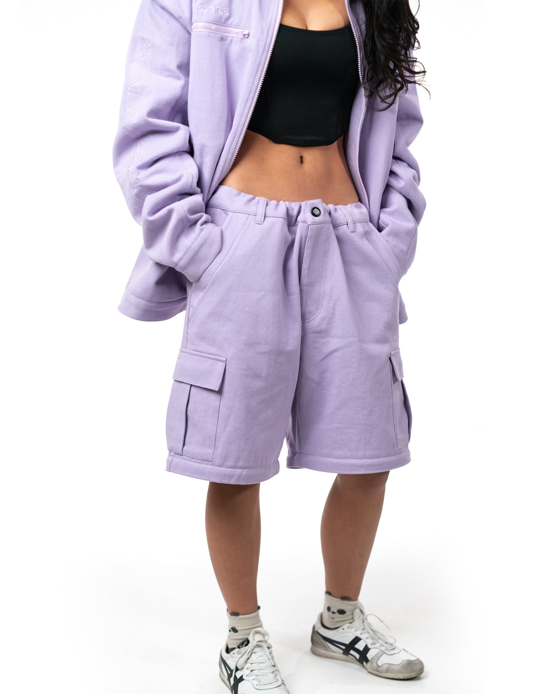 Model wearing matching lavender jacket and the zipped off Killua cargo shorts version of the pants