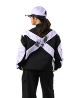 Back view of female model wearing the officially licensed Killua racing jacket with lavender X graphic