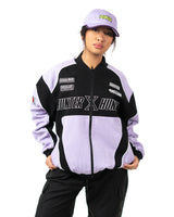 Full front view of female model standing in the officially licensed Killua racing jacket with matching cap
