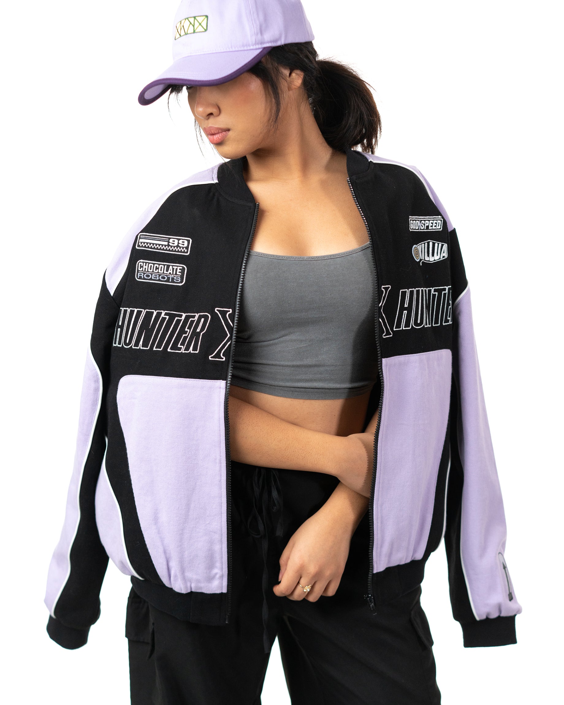 Front view of female model wearing the unzipped lavender and black Killua racing jacket