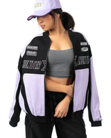 Front view of female model wearing the unzipped lavender and black Killua racing jacket