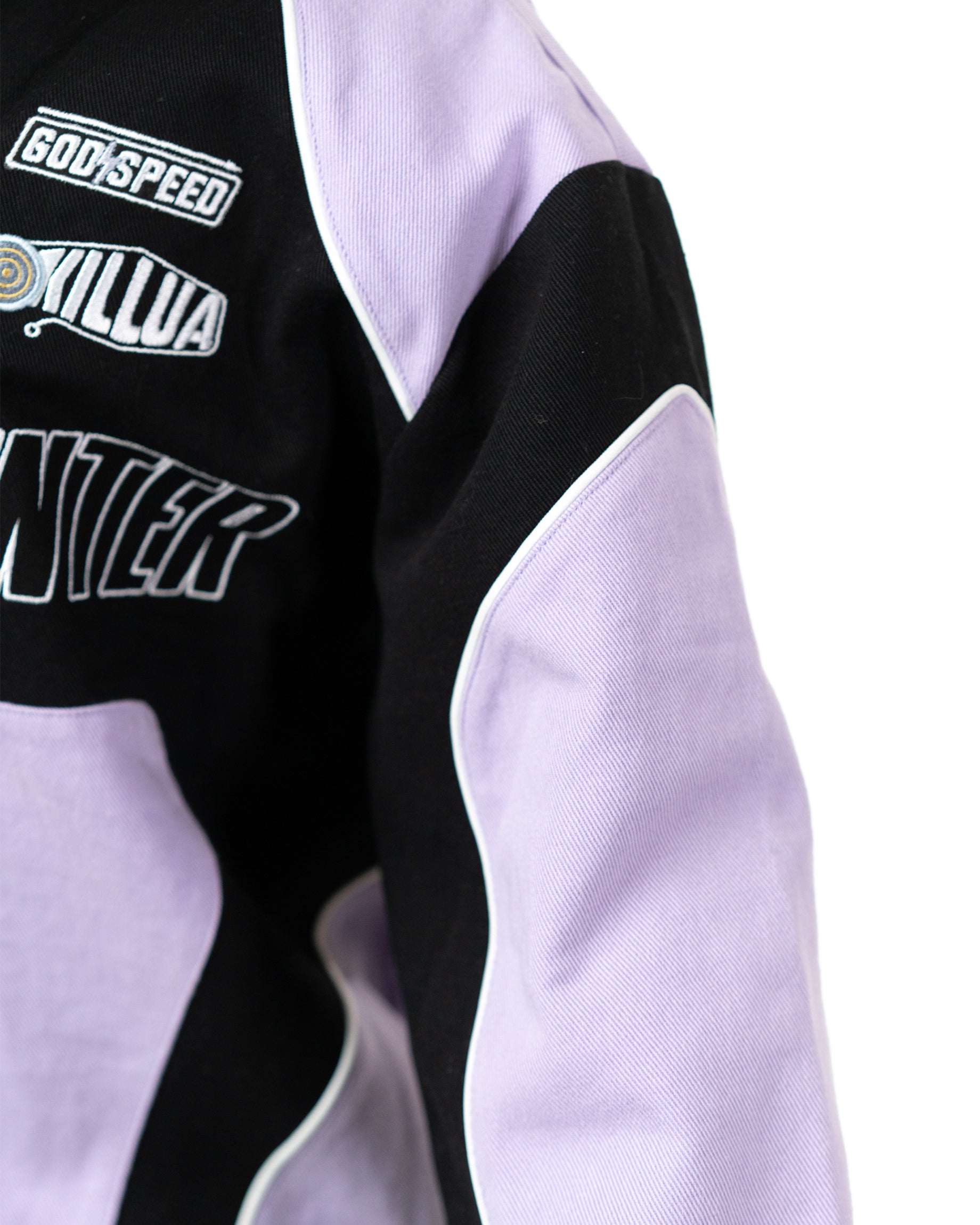 Side profile of the Killua racing jacket sleeve highlighting the Godspeed and Killua embroidered patches