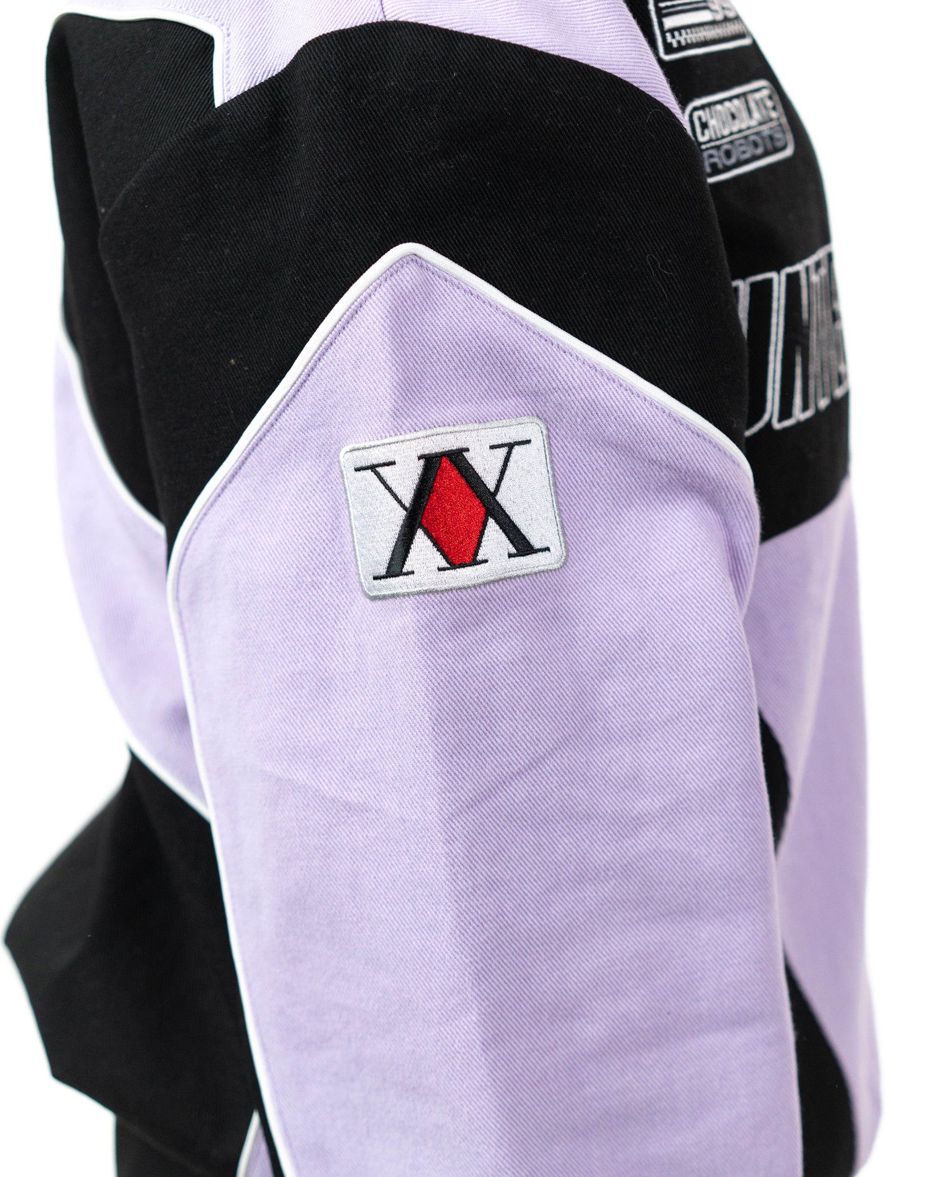 Close up of the sleeve of the Killua racing jacket highlighting the embroidered Hunter Association license patch
