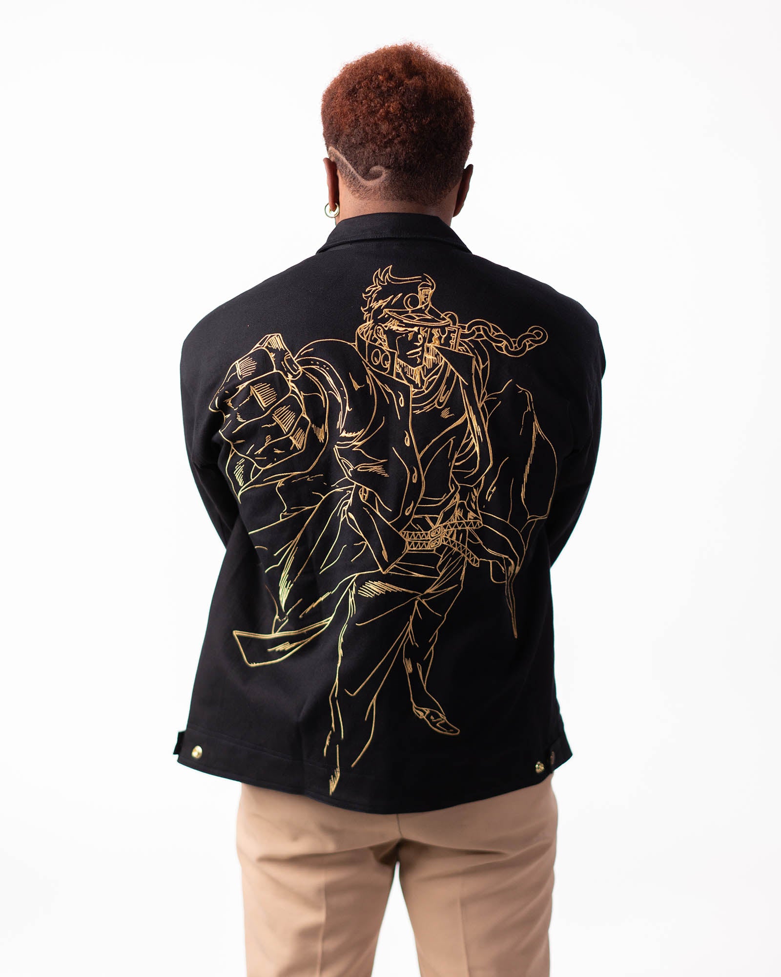 Back view of the Jotaro Kujo black jacket featuring gold Star Platinum embroidery.