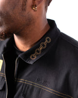 Close-up of the jacket collar featuring Jotaro's gold chain embroidery.