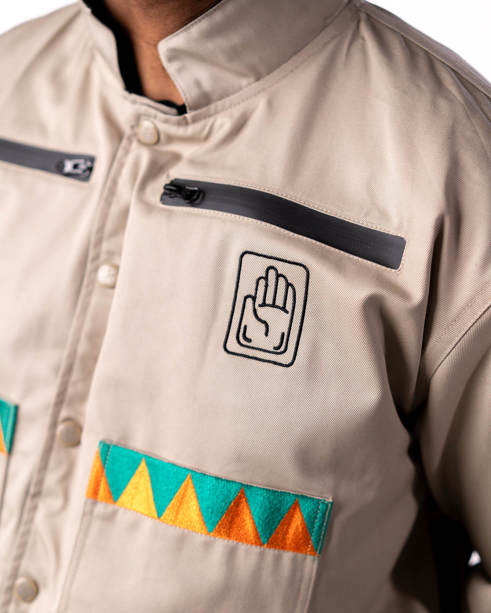 Close-up of the beige side chest featuring the palm symbol and triangle trim.