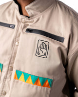 Close-up of the beige side chest featuring the palm symbol and triangle trim.