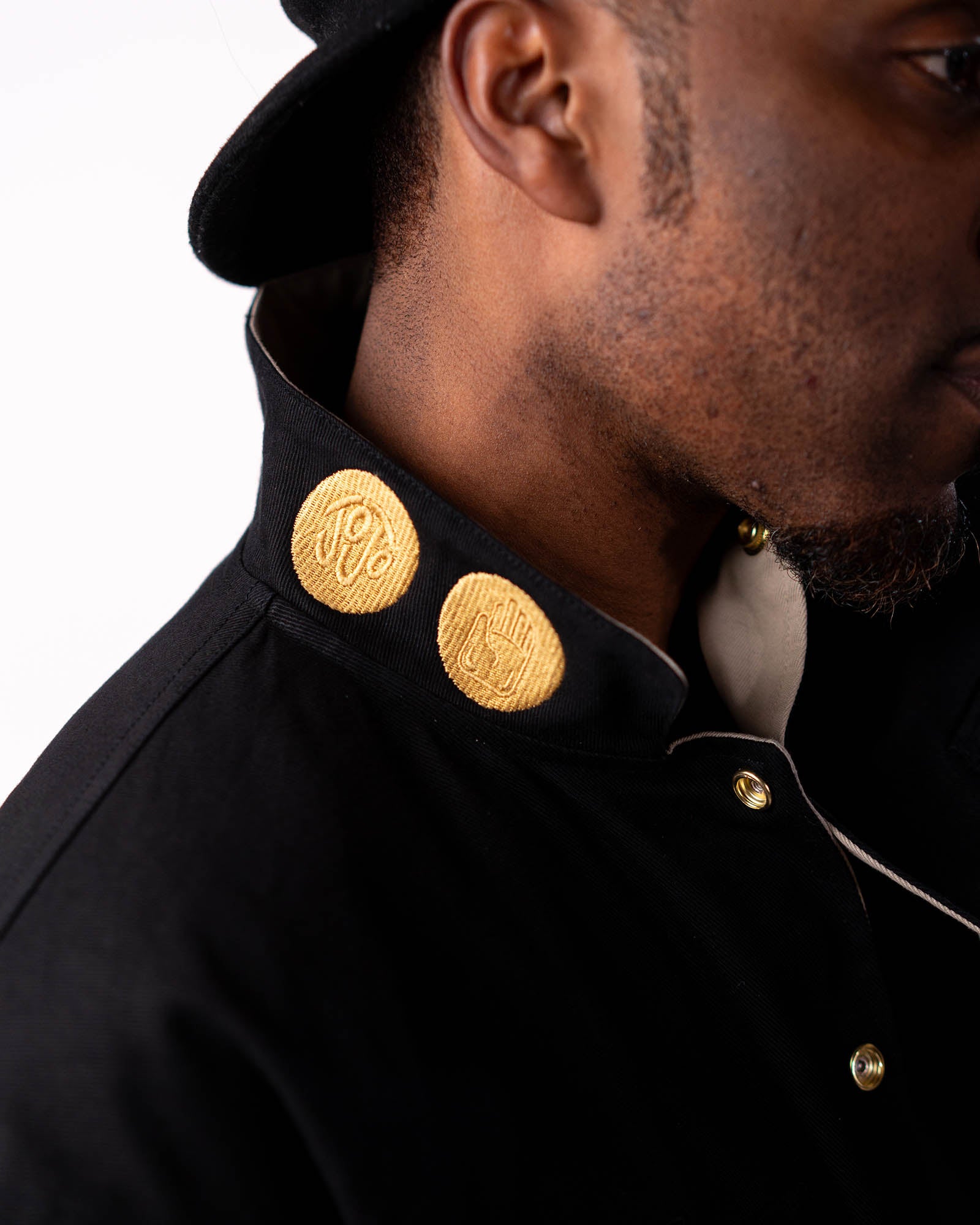 Close-up of the black side collar featuring Jotaro's signature gold buttons.