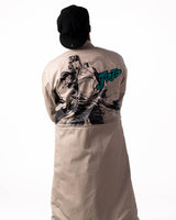 Back view of the beige side featuring black-and-white art with teal JoJo embroidery.