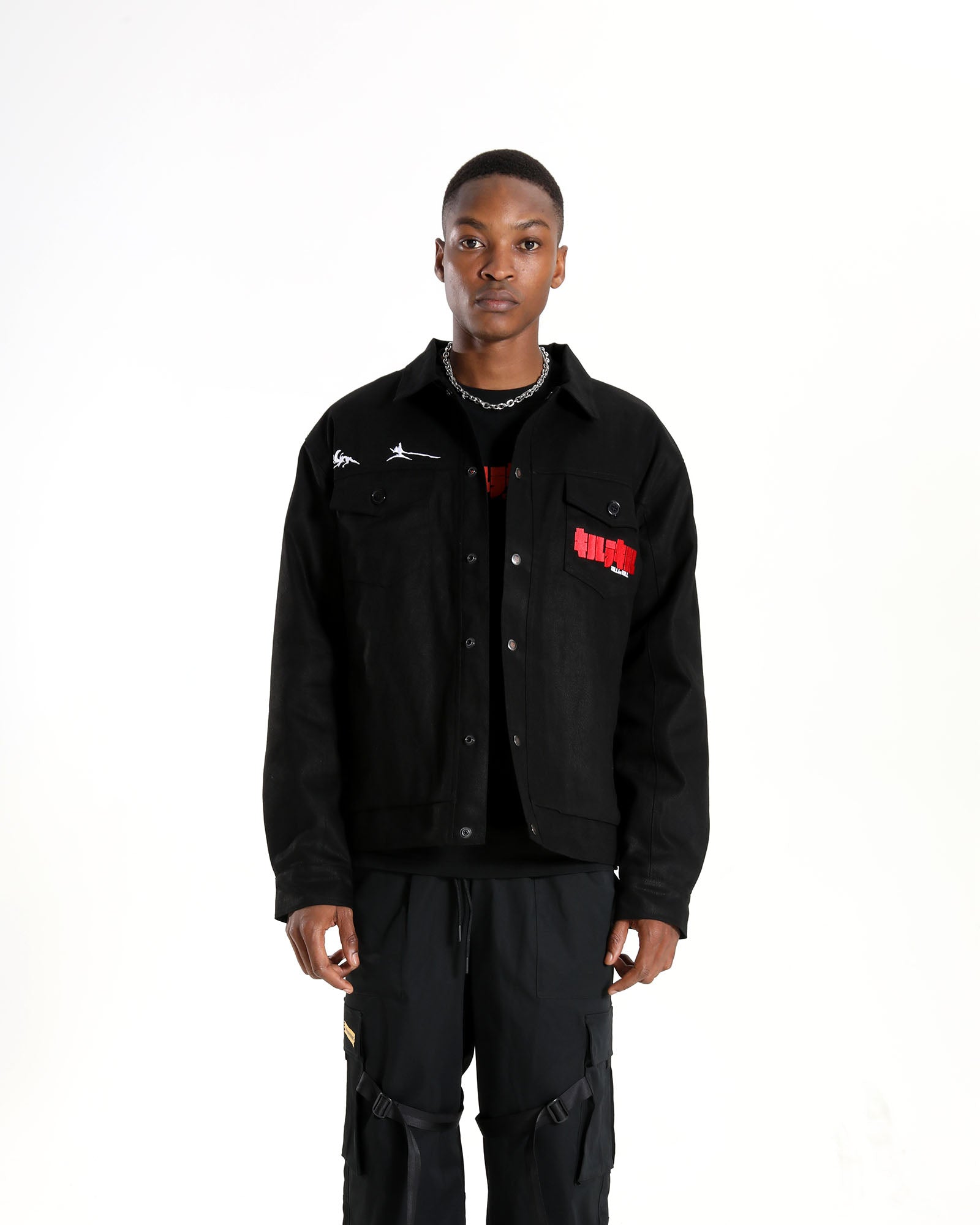 Full-length shot of the Ryuko silhouette jacket styled with black cargo pants.