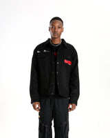 Full-length shot of the Ryuko silhouette jacket styled with black cargo pants.